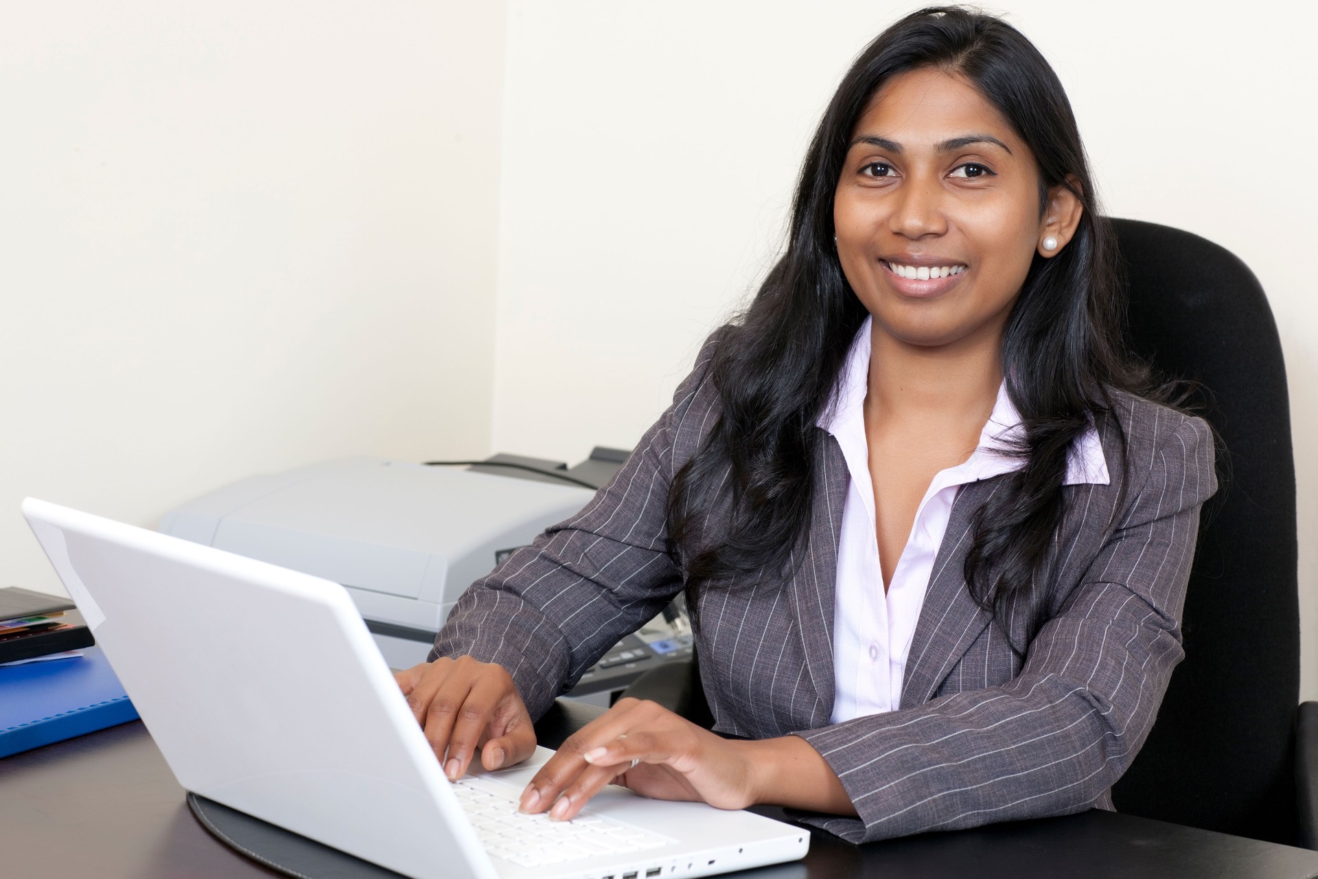 Indian business woman working on laptop.